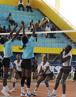 WINNING SPIKE; APR's Dorcus Ndasaba's spike is blocked off court by RRA to help the army retain the Carre'd'AS title. (Photo T. Kisambira)