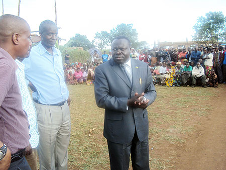 Minister Christophe Bazivamo (R), Dr. Ephraim Kabaija (L) during a meeting with residents of Musha. 