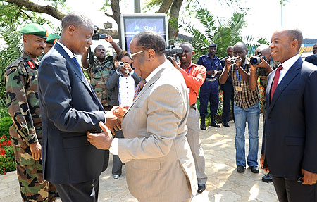 Defence Minister James Kabarebe (L) welcomes his  DR Congo counterpart Charles Mwando Nsimba at Kigali International Airport on Monday. (Photo J Mbanda)