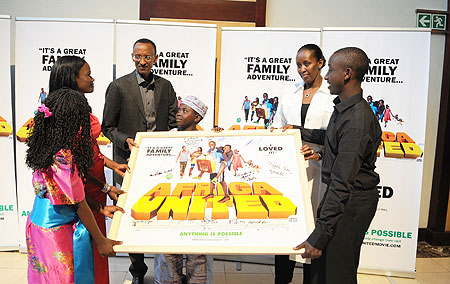 The President and the First Lady receiving an autographed poster from the cast of the acclaimed movie, u201cAfrica Unitedu201d (Photo Urugwiro Village)