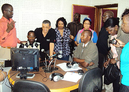 Aldo Havugimana (L), the director of Radio Salus addressing the visiting Namibian MPs at the station (Photo; P. Ntambara)