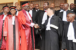 High Court President, Justice Johnston Busingye congratulat,es Tom Allen and other newly sworn in Advocates yesterday (Photo; J. Mbanda)
