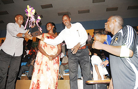 L-R; Jean Bosco Kazura, Peace Shyaka, Alex Kagame and APR Captain Mbuyu Twite displaying the Shyaka Claver Memorial Cup (photo T.Kisambira)