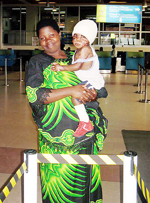 Esperance Nyiramajyambere with her baby at Kigali International Airport heading for treatment in Nairobi.