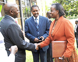 Permanent Secretary in the Ministry of Infrastructure Marie Claire Mukasine (R) greets Kenya Revenue Authority  Commissioner General, Michael Waweru as Eugene Torero looks on. (Photo J Mbanda)