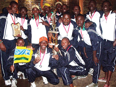 Rwandau2019s U19 Cricket players pose for a photo with the ICC Africa U19 World Cup qualifiersu2019 runners up trophy. Rwanda finished second to Nigeria and received a rapturous welcome after touching down yesterday.