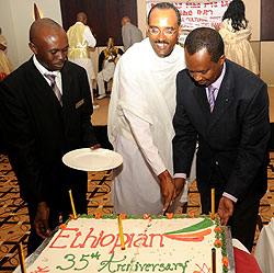 Minister  Karega cutting the cake with Biruk Endeshaw. (Photo; T.Kisambira)