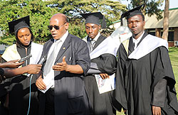 KIE Vice Rector, James Vuningoma, talking to reporters as the Graduates   Nakure (L) , Ndegeya and Nizeyimana look on. (Photo J Mbanda)