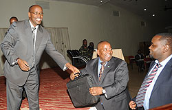 Local Government Minister James Musoni (L) hands over a laptop to the Governor of Northern Province Aime Bosenibamwe. (Photo / J. Mbanda)