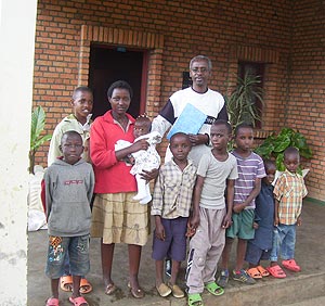 Kageyo SOS children village Director Rwabuhungu poses with some of the vulnerable children on Thursday. (Photo A.Gahene)