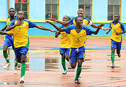 AM THE MAN; Junior Wasp's second goal hero Charles Mwesigye (left) beats his chest and as he celebrates with teammates in the opening game against Burkina Faso at Amahoro stadium yesterday. (T. Kisambira)
