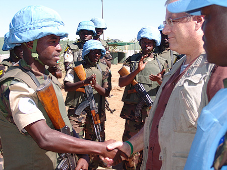 Gration shaking hands with a Rwandan peacekeeper at Shangil Tobaya (Photo J.Karuhanga)