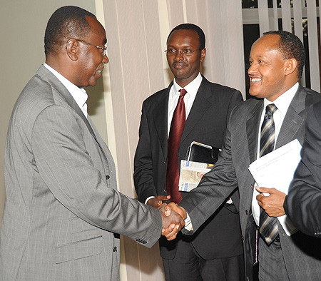 Premier Bernard Makuza greets PSF vice president, Faustin Mbundu, while MINICOM PS, Emmanuel Hategeka, looks on. (Photo J Mbanda)
