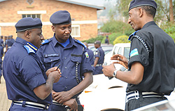 Commissioner General of Police Emmanuel Gasana (L) listens to CID boss, ACP Christopher Bizimungu (R) as Police Spokesperson Sup. Eric Kayiranga looks on. (Photo J Mbanda)