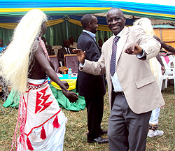 General Rwarakabije (L) joins ex-child combatants in traditional dance. Photo S.Rwembeho