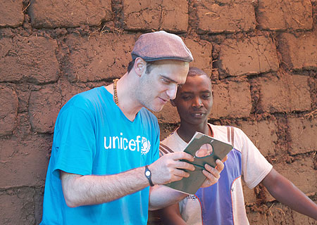 A youth shows Anatole Taubman a family photo album