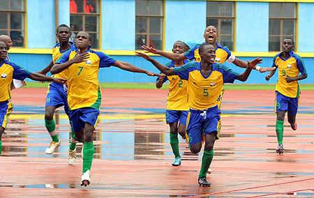 Junior Waspu2019s players join Charles Mwesigye (left) as he celebrates after scoring in the opening game against Burkina Faso.