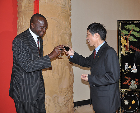 Shu Zhan, the new Chinese Ambassador, toasts with Minister Joseph Habineza during the ceremony (Photo. Kisambira)