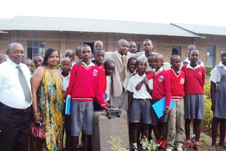 Col (Rtd) Thaddeo Gashumba (left) and his wife in a group photo with the 2010 best candidates. (Photo.D Ngabonziza)