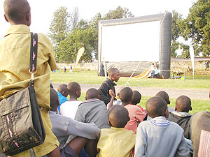A crowd in rural Rwanda waits anxiously to watch a film on one of Hillywoods inflatable screens. (File Photo).