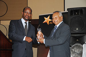 RDB CEO John Gara awards the MD of SORWATHEJ C Alles during the RDB Awards ceremony on Friday. (Photo T Kisambira)