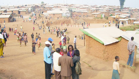 MIDIMAR camp representative Mark Shakagabo (in white shirt) consults with District and Refugee officials, during the visit. (Photo: A. Gahene)