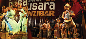 L-R : The Black Roots queen dancers take on the stage; lad in a traditional outfit, Mohamed ( c) demonstrates his exceptional drumming skills.