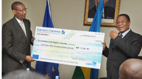 Finance Minister John Rwangombwa  (L) receives a cheque from COMESA Secretary General Sindiso Ngwenya. (Photo J Mbanda)