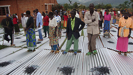 Rwinkwavu residents ready to take iron sheets home. (Photo S. Rwembeho)