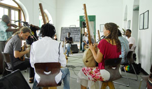 Hands on the instruments. Students in class learning Taarab music.