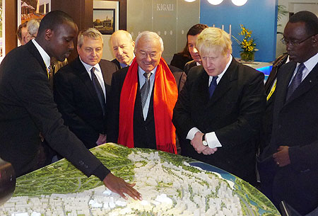 L-R-KCCu2019s urban planner, Joshua Ashimwe explains the Kigali master plan to the Mayors of Cannes, Bernard Brochand (in red scarf) and London, Boris Johnson, as Premier Makuza looks on. (courtesy photo)