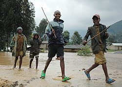 Children play in a flooded area in Western Province; authorities in the province have been advised to include disaster management in its 20112012 budget (File photo)