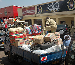 A man unloads commodities from a truck in Kigali city, KCC is currently processing documents of tax defaulters in the city for court proceeding.(File photo)