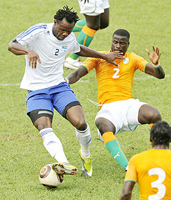 Dropped: Amavubi defender Louis Anuete battling for position with Cote du2019Ivoireu2019s Enmmanuel Eboue during the 2012 Nation Cup qualifier. 