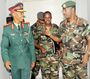 Chief of Defence Staff Lt.Gen Charles Kayonga (R) with his Botswana counterpart Lt Gen.Tebogo Masire (L) and Chief of Staff of land Forces Lt Gen Ceasar Kayizari on Monday. The Botswana Army chief was in the Country last week.(Photo J Mbanda)