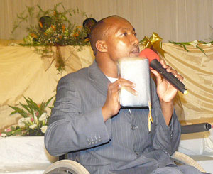 Pastor Gacura preaching on pulpit of the Nyabugingo church