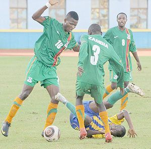 Rwanda's U-23 left back James Tubane sandwiched by Zambian players. Rwanda was knocked out of the 2012 London Olympic Games after losing 3-0 on aggregates. (Photo / T. Kisambira)