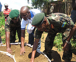 Brig.Gen Eric Murokore (R) and the Chief Operating Officer of BK, Lawson Naibo (c) together with another senior RDF officer launching the kitchen gardens (Photo: Dias Nyesiga)