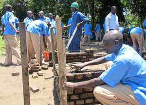 Former street children at the Youth Rehabilitation and Vocational Skills Development Centre, Iwawa Island, learning how to build (Photo D. Umutesi)
