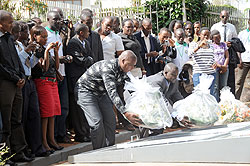 Ministry of Youth PS Edward Kalisa (right laying wreath) leads EAC youth in paying tribute to Genocide victims at Gisozi. (Photo J Mbanda)