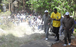 CNLG's Jean De Dieu Mucyo(middle) leads mourners in Bisesero (photo S Nkurunziza)