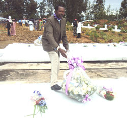 RIP Alloys Rwamasirabo lays a wreath at the mass grave in which remains of his nine children were laid to rest (Photo/ S Nkurunziza