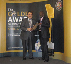 Januario Mucyo (right) receives the Golden Award on behalf of BK, in Germany. (Courtesy Photo)