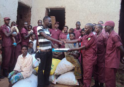 LDF Muhanga district commander, Evariste Nkurunziza, hands over their donations  to Kagitarama orphans. (Photo D Sabiti).