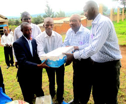 Serena Hotel Country Manager, Charles Muia (2nd Right), handing over some of the donated items to David Tuganimana (2nd Left) the President of the Abahumuriza  association