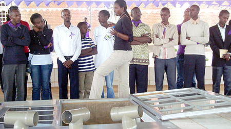 The Kimironko youth listen to a guide at Nyamata Genocide Memorial site.(Photo G. Mugoya)