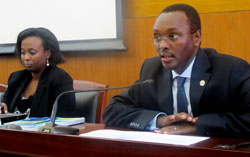 Emmanuel Hategeka, the PS MINICOM speaking during the Intellectual Property Rights workshop. On his left is Louise Kanyonga, the Registrar General at RDB (Photo T.Kisambira).