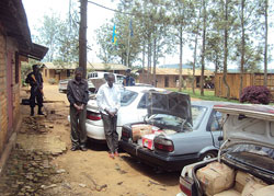 The two suspects arrested for trafficking illicit alcohol stand next to their impounded vehicles at Nyagatare Police post (Photo Dan Ngabonziza).