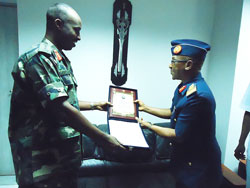 CDS Lt Gn Charles Kayonga receives a gift from Nigerian Air Vice Marshal Ahmed Tijjani Muu2019azu, yesterday (Courtsey Photo)