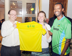 The British High Commissioner Benedict Llewellyn-Jones and his wife receive a junior wasps' jesery from Kumunini's Managing Director Martin Semukanya. (Photo: T. Kisambira).